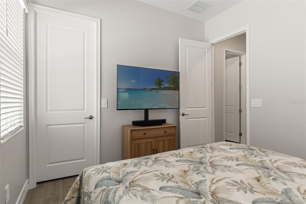 4661 Southern Valley Loop Brooksville, FL 34601 - Photo 26 of 62 a bedroom with a bed and a flat tv screen in it