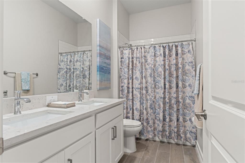 4661 Southern Valley Loop Brooksville, FL 34601 - Photo 29 of 62 a bathroom with a double vanity sink toilet and a tub
