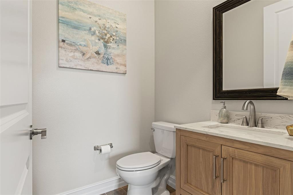 4661 Southern Valley Loop Brooksville, FL 34601 - Photo 32 of 62 a bathroom with a toilet sink and mirror