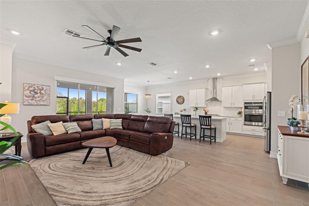 4661 Southern Valley Loop Brooksville, FL 34601 - Photo 9 of 62 a living room with furniture kitchen view and a wooden floor