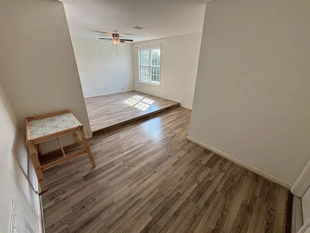 a view of a room with wooden floor and staircase