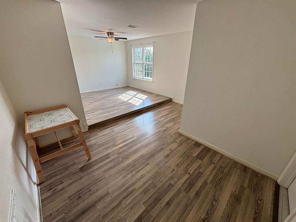 2113 Via Del Norte Carrollton, TX 75006 - Photo 12 of 24 a view of a room with wooden floor and staircase