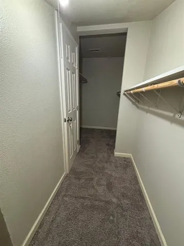 an entryway door with a hallway in the house