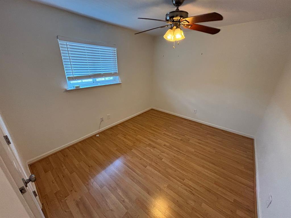 2113 Via Del Norte Carrollton, TX 75006 - Photo 19 of 24 a view of empty room with wooden floor and fan