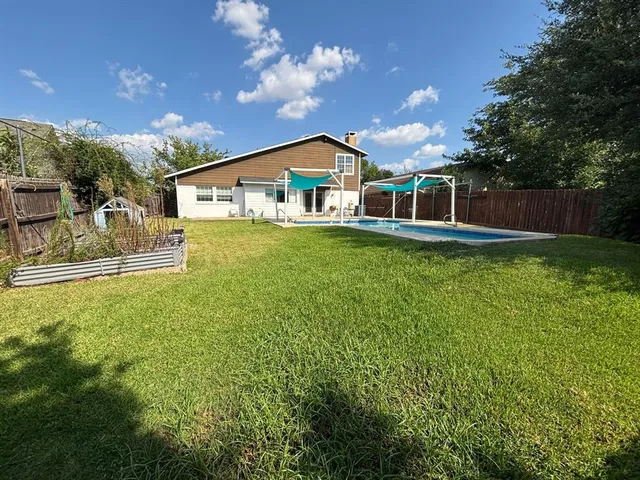 a view of a house with a yard and deck