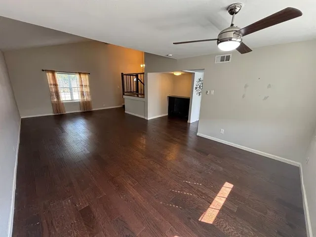 wooden floor in an empty room with a window