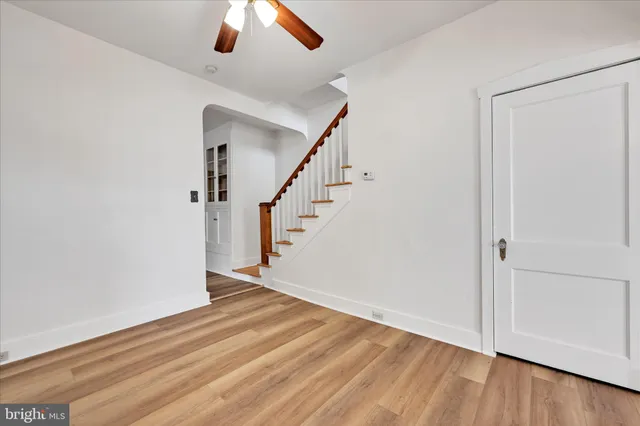 a view of entryway and hall with wooden floor
