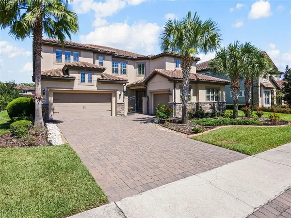 a front view of a house with a garden and patio