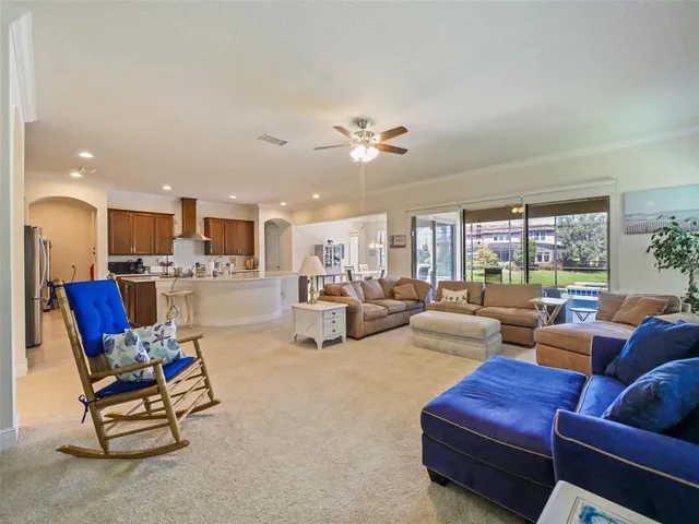 a spacious bedroom with a bed window and flat screen tv