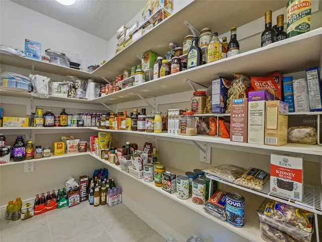 a spacious bathroom with a granite countertop toilet sink and mirror