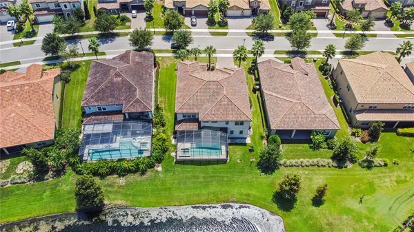 an aerial view of residential houses with outdoor space