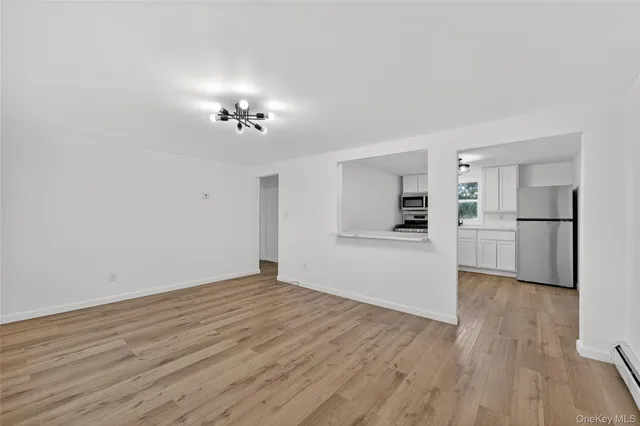 a view of a kitchen with wooden floor and a kitchen