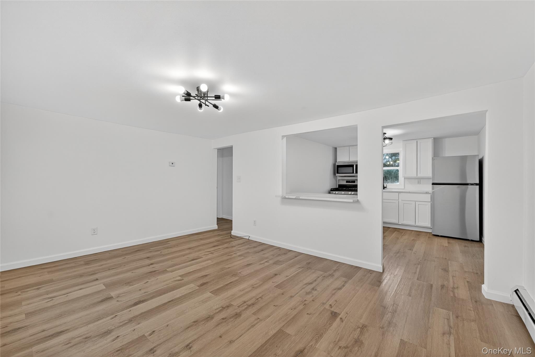193 Schutt Road Middletown, NY 10940 - Photo 11 of 20 a view of a kitchen with wooden floor and a kitchen