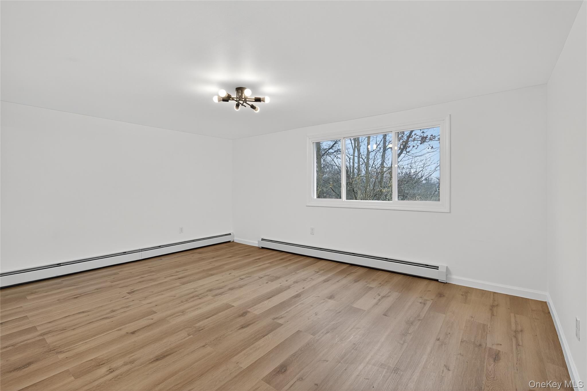 193 Schutt Road Middletown, NY 10940 - Photo 13 of 20 wooden floor in an empty room with a window