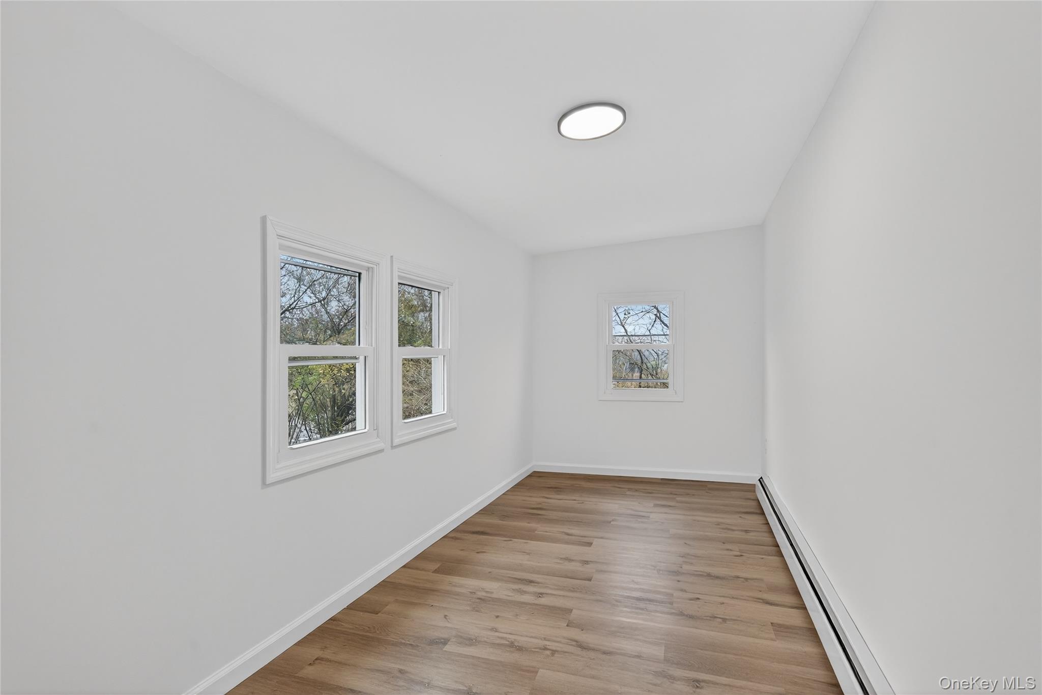193 Schutt Road Middletown, NY 10940 - Photo 4 of 20 a view of an empty room with wooden floor and a window