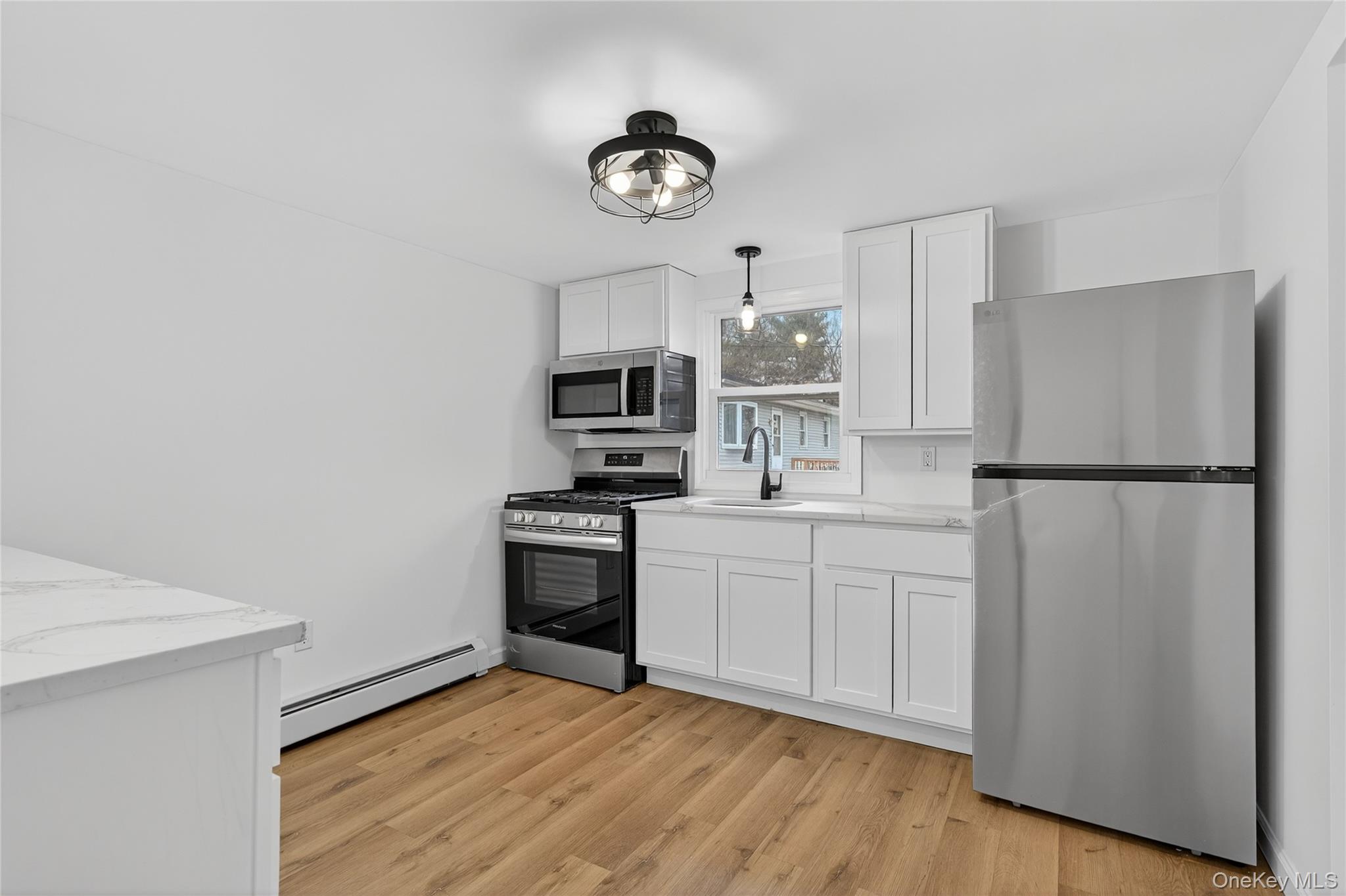 193 Schutt Road Middletown, NY 10940 - Photo 6 of 20 a kitchen with cabinets stainless steel appliances and wooden floor