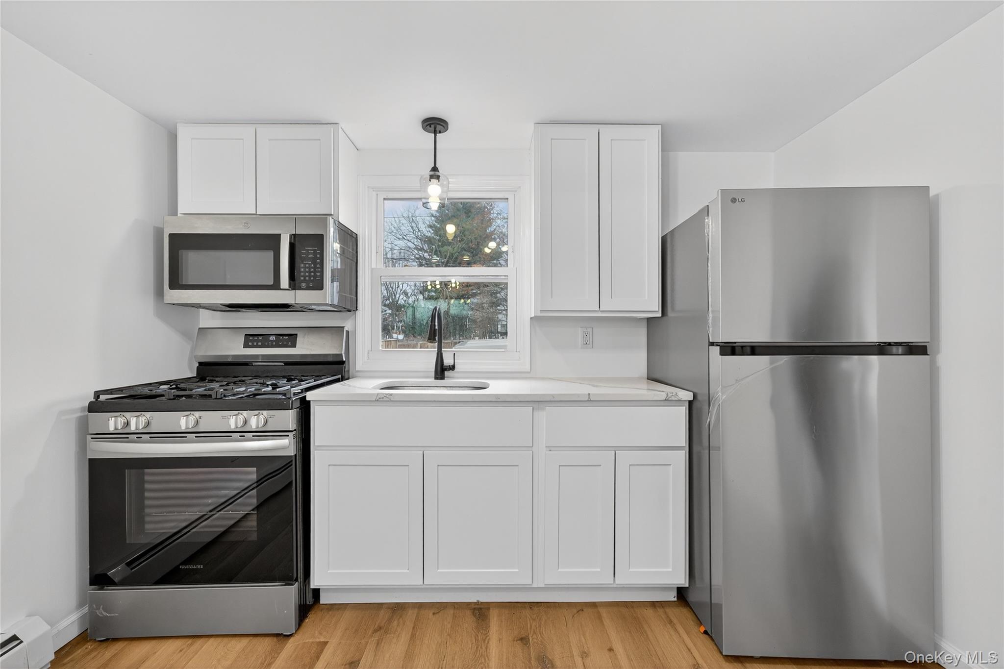 193 Schutt Road Middletown, NY 10940 - Photo 7 of 20 a kitchen with a stove a refrigerator and a microwave