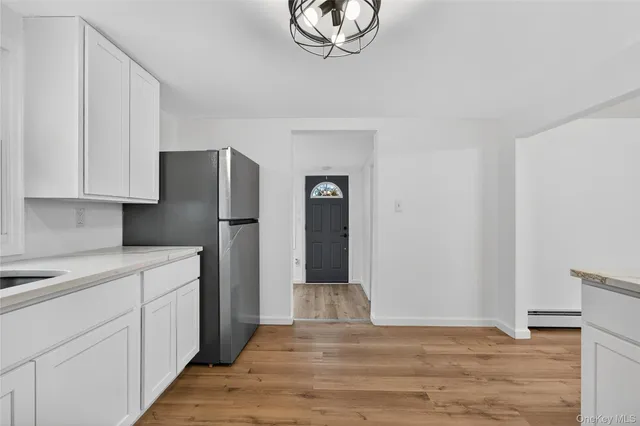 a kitchen with a refrigerator cabinet and a sink