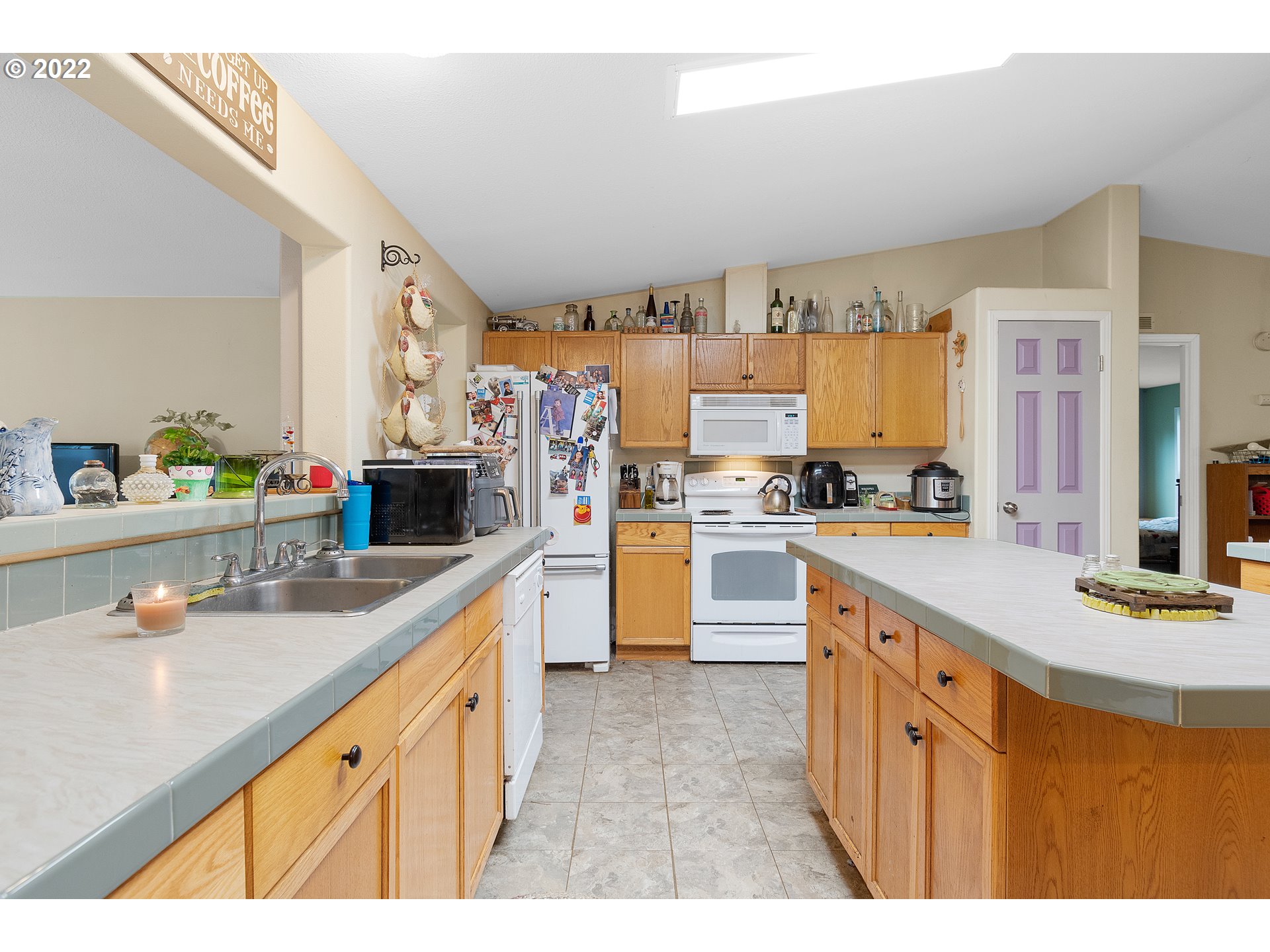 121 Brentwood Road Longview, WA 98632 - Photo 5 of 32 a kitchen with kitchen island granite countertop a sink appliances cabinets and a counter top space