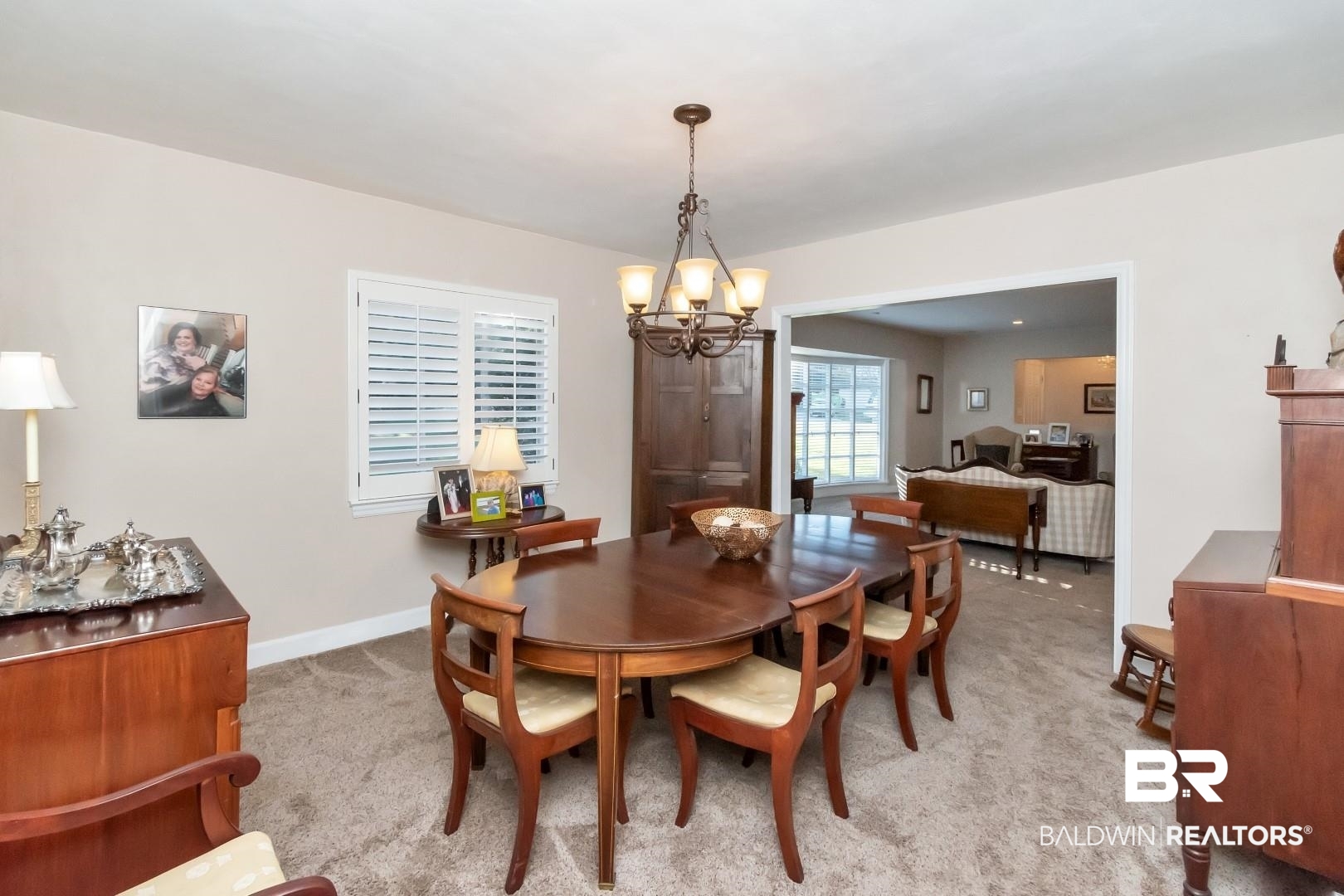 302 Springwood Drive East Mobile, AL 36608 - Photo 8 of 35 Dining space with light carpet and a chandelier