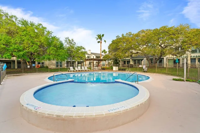 a view of a swimming pool with an outdoor space and seating area