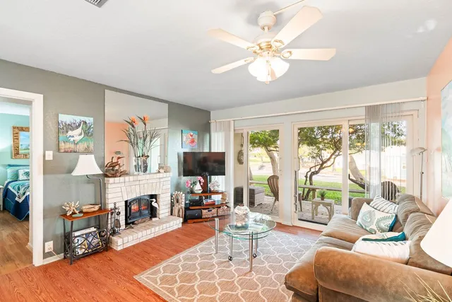 a living room with fireplace furniture and a flat screen tv
