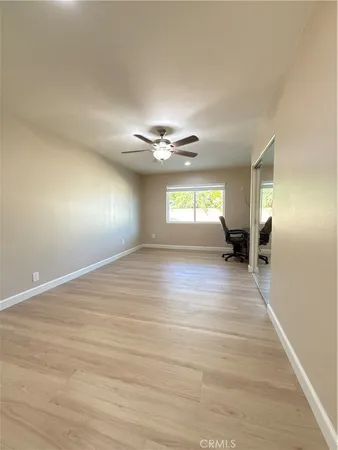 a view of an empty room with a ceiling fan