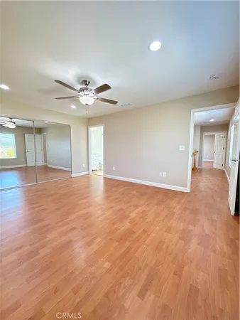a spacious bathroom with a granite countertop sink a mirror and shower