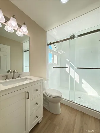 a kitchen with stainless steel appliances granite countertop a refrigerator a stove and a wooden floors