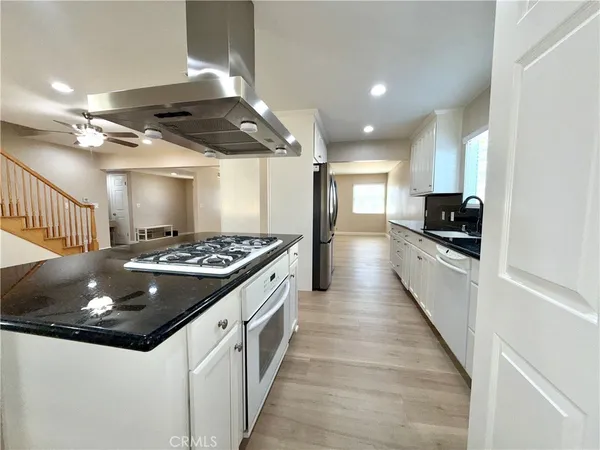 a view of washer and dryer with kitchen in the background