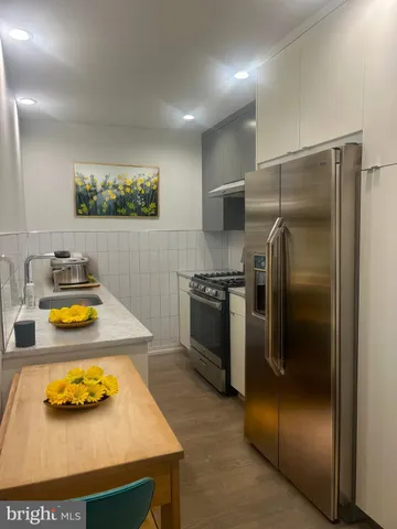 a kitchen with a refrigerator and a stove