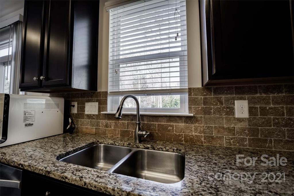 4008 Fallondale Road Waxhaw, NC 28173 - Photo 18 of 44 a kitchen with a sink a stove and cabinets