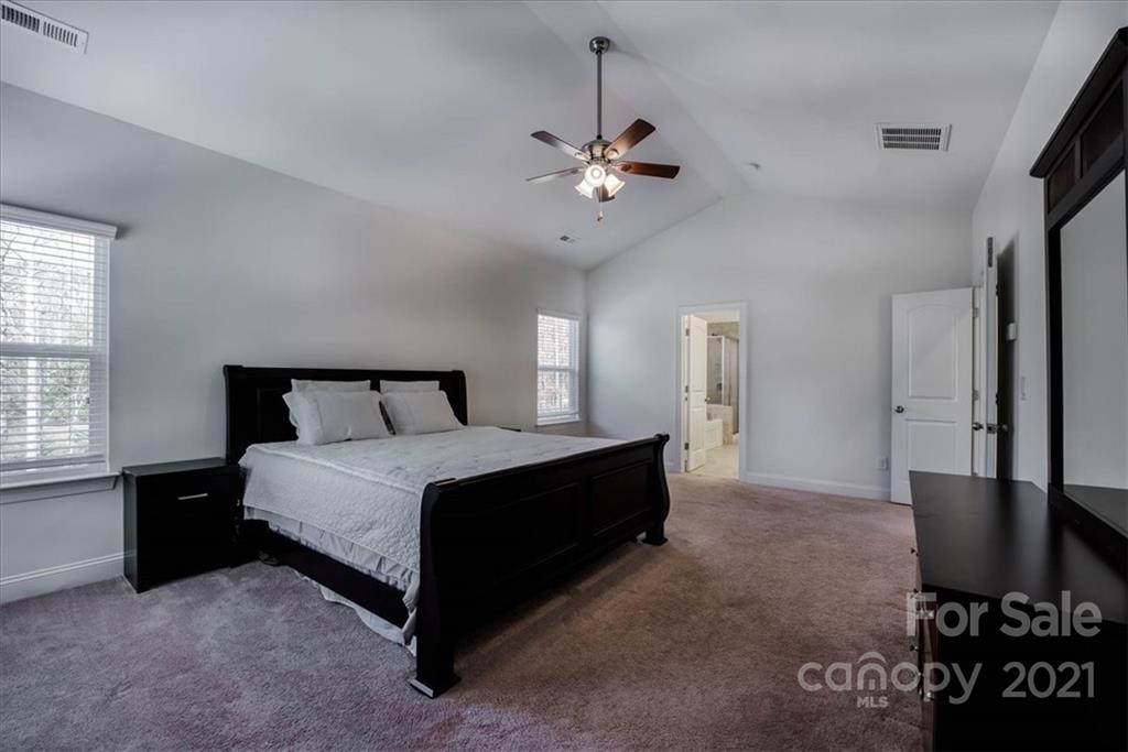 4008 Fallondale Road Waxhaw, NC 28173 - Photo 24 of 44 a spacious bedroom with a bed and a flat screen tv