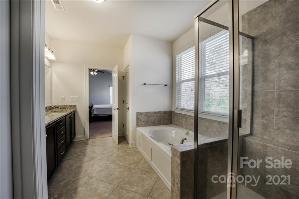 4008 Fallondale Road Waxhaw, NC 28173 - Photo 29 of 44 a bathroom with a tub sink and mirror