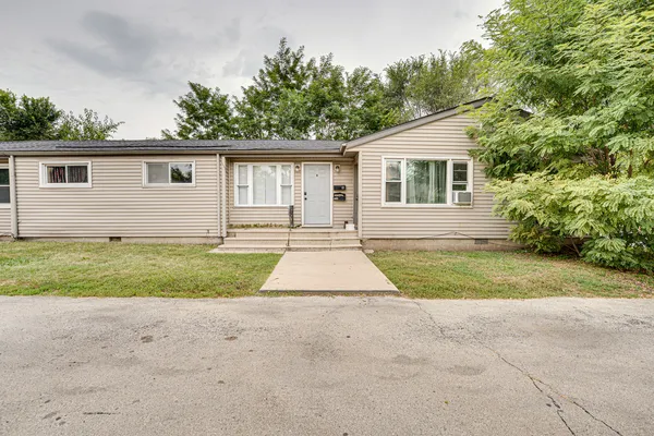 a front view of house with yard and trees
