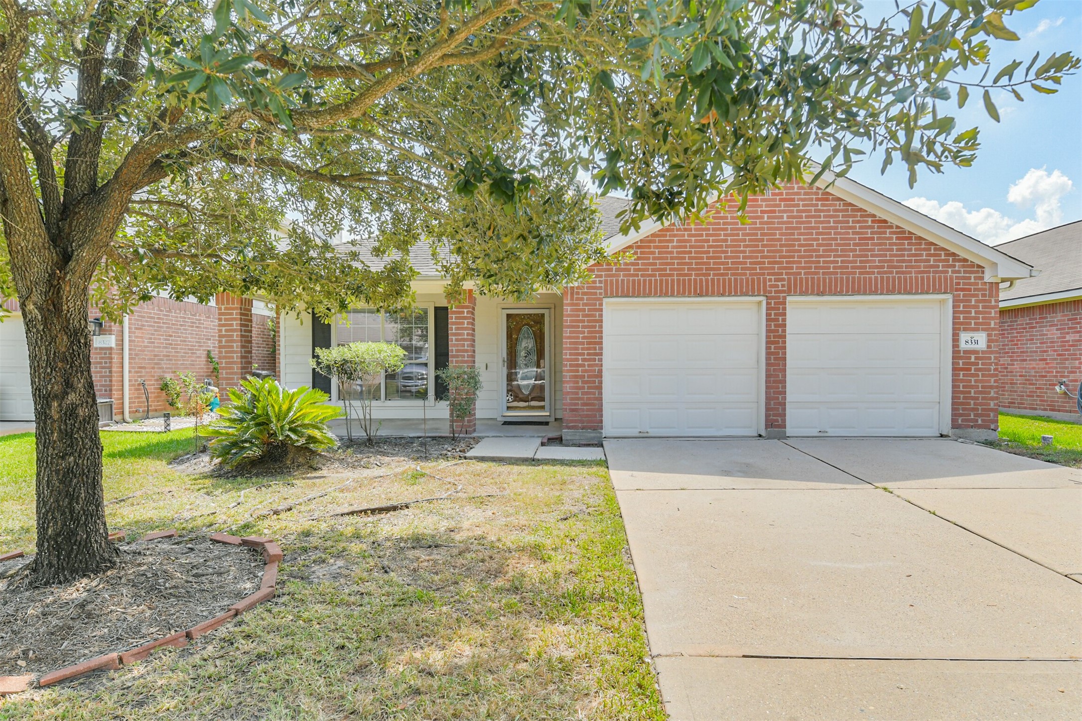 8331 Loetsch Ridge Way Spring, TX 77379 - Photo 1 of 31 Welcome to this inviting one-story home featuring four bedrooms, two full bathrooms, and a two-car garage. The traditional brick exterior, mature shade tree, and covered front entry create a warm and welcoming first impression.