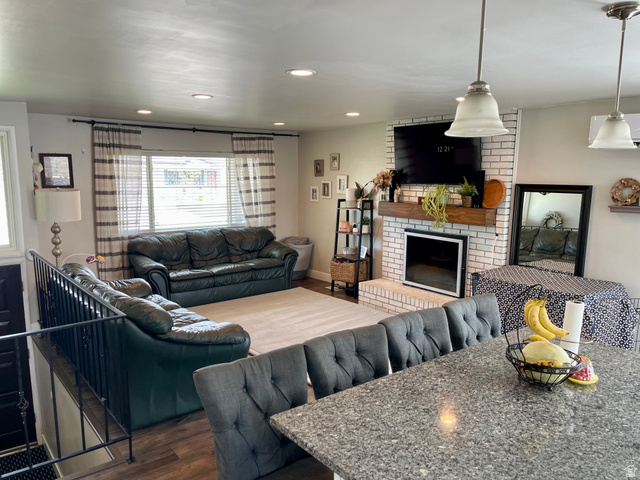 2444 Quail Run Drive Sandy, UT 84093 - Photo 5 of 23 Open-concept living area with LVP flooring and recessed lighting