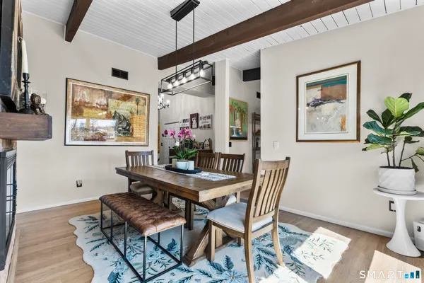 a view of a dining room with furniture window and wooden floor