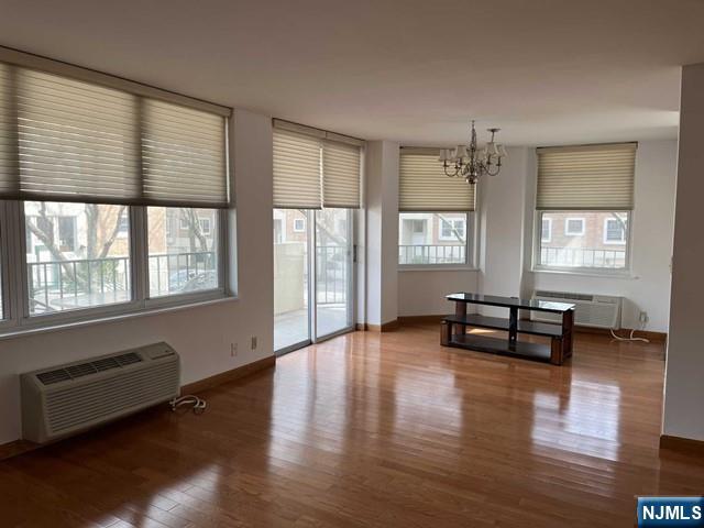 200 Grand Cove Way, Unit 2A Edgewater, NJ 07020 - Photo 1 of 12 a living room with furniture and wooden floor