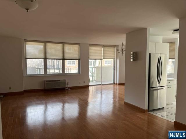 200 Grand Cove Way, Unit 2A Edgewater, NJ 07020 - Photo 2 of 12 a view of an empty room with a window and wooden floor