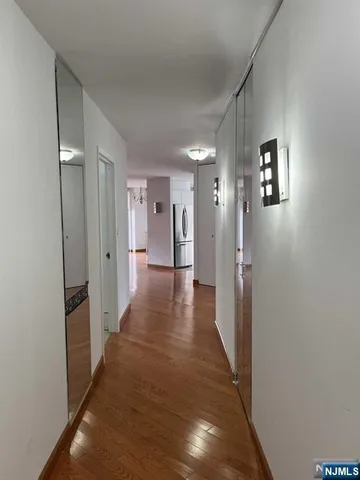 a view of a hallway with wooden floor