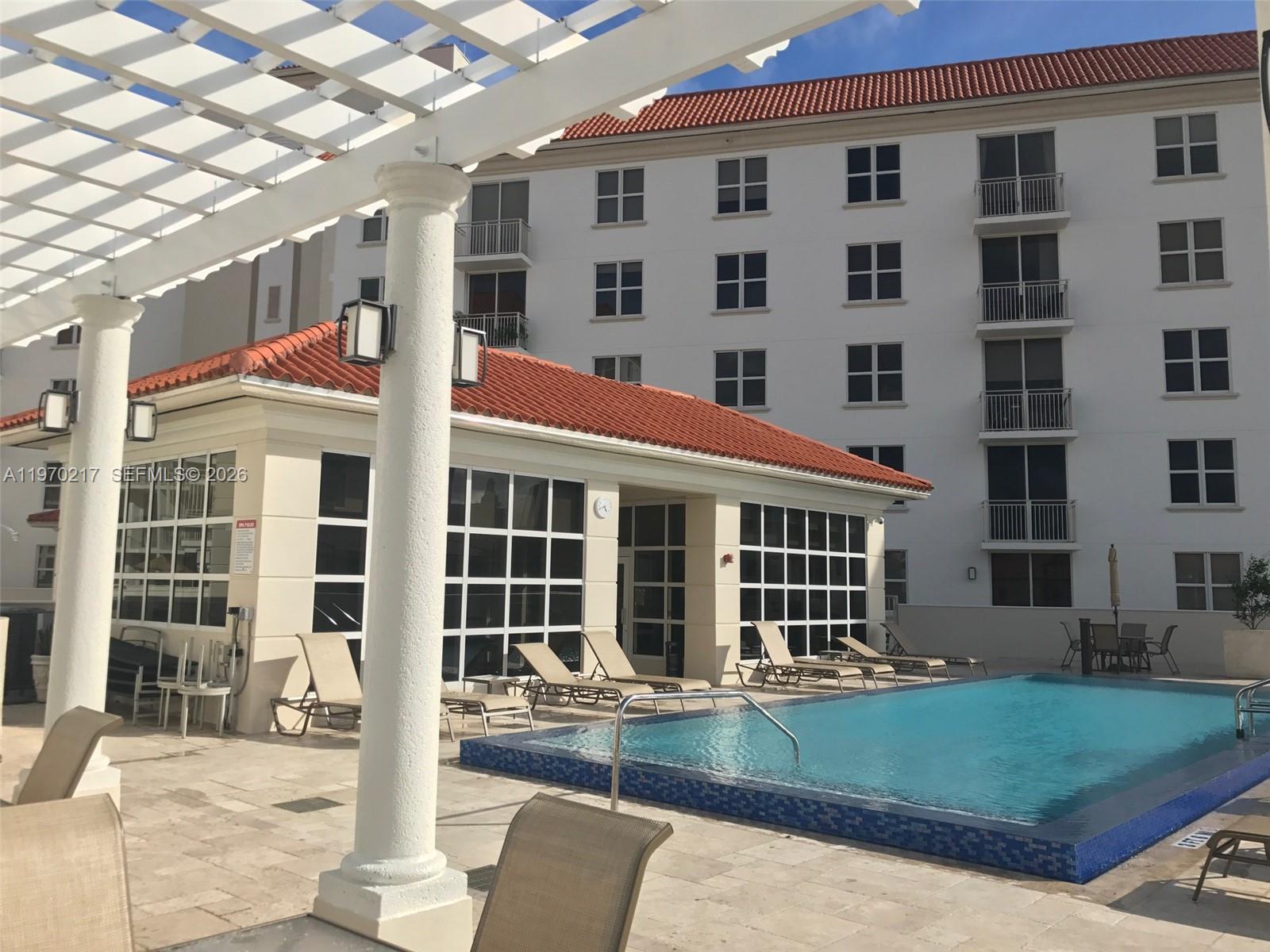 2030 Douglas Road, Unit 708 Coral Gables, FL 33134 - Photo 3 of 8 front view of a building with a yard