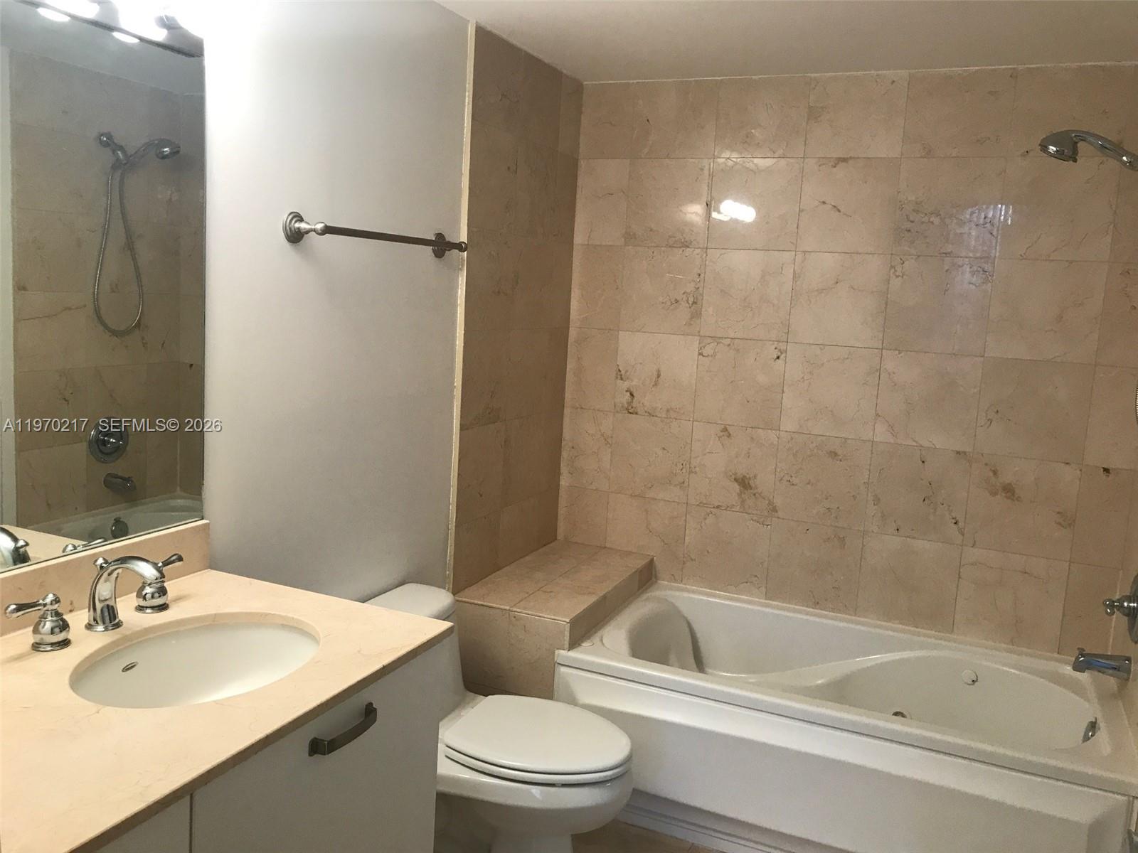 2030 Douglas Road, Unit 708 Coral Gables, FL 33134 - Photo 8 of 8 a bathroom with a sink a toilet and shower