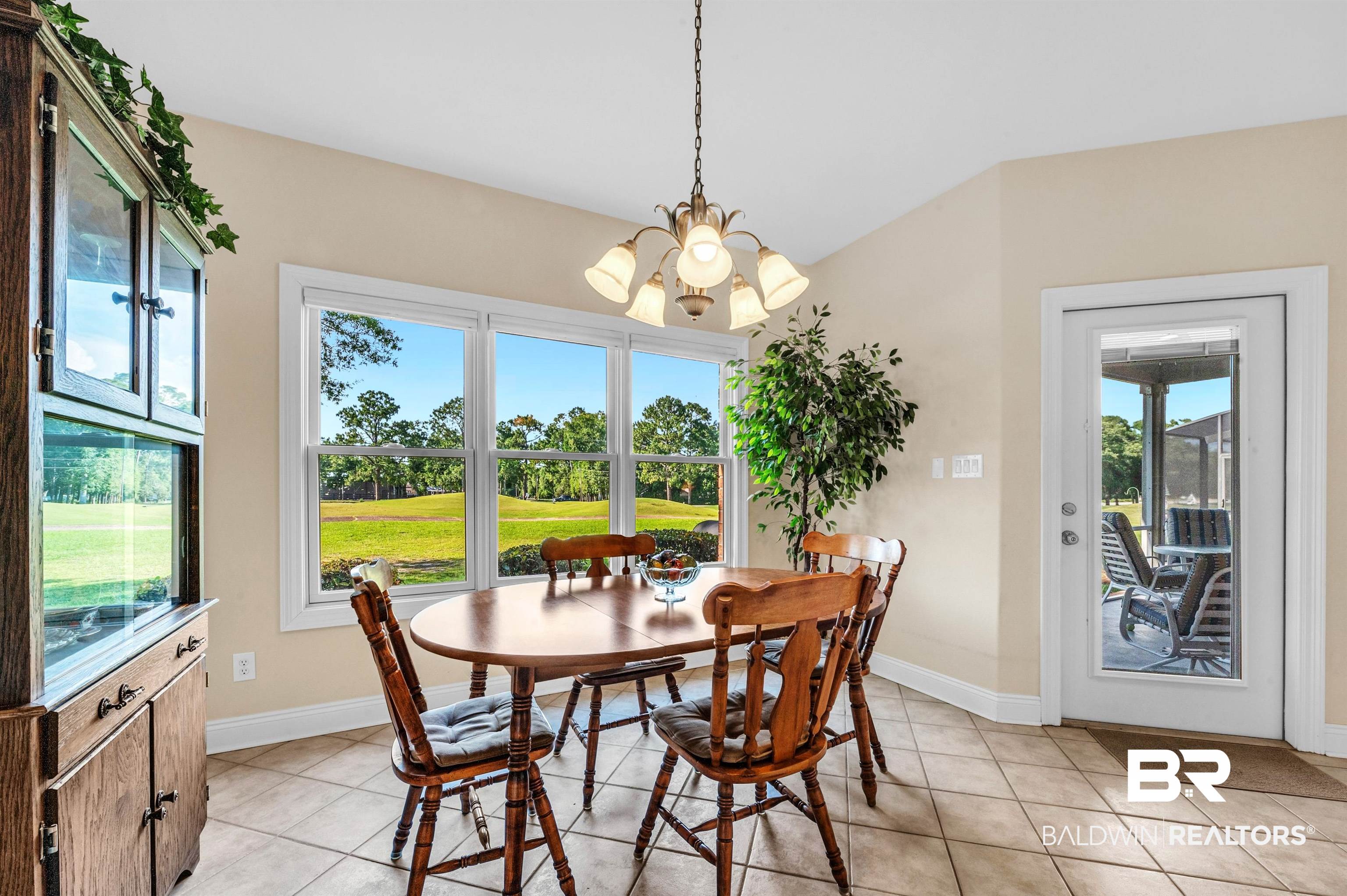 22739 Inverness Way Foley, AL 36535 - Photo 37 of 80 Dining area with healthy amount of natural light, light tile patterned floors, and a chandelier