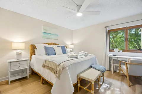 a bedroom with a bed and a table in it
