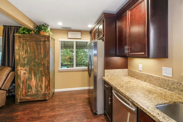 a kitchen with granite countertop a sink and a granite counter top