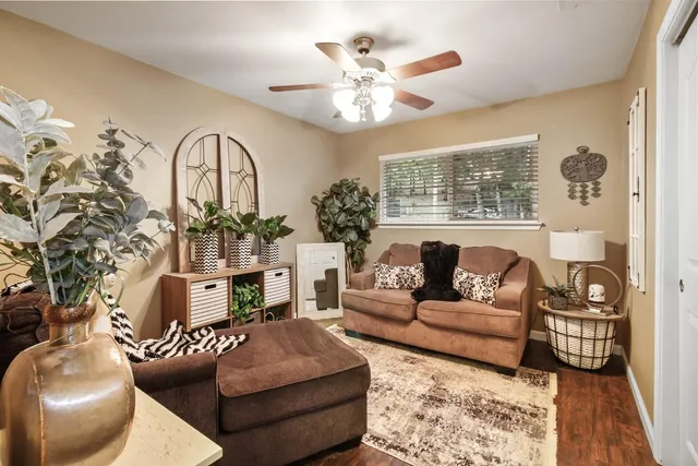 a living room with furniture a chandelier and a fireplace
