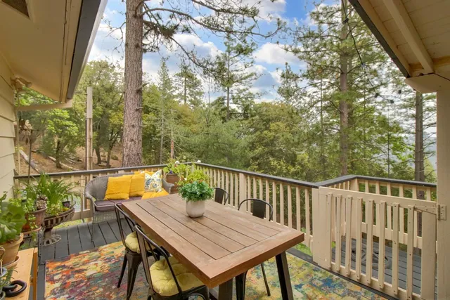 a balcony with wooden floor and outdoor seating