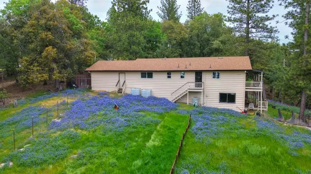 a view of a house with a deck and furniture