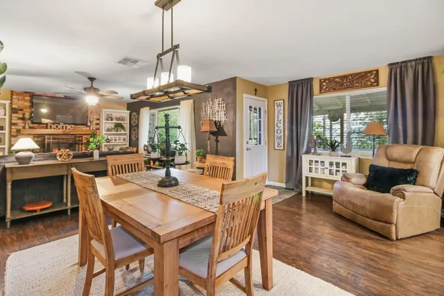 a dining room with furniture a chandelier and window